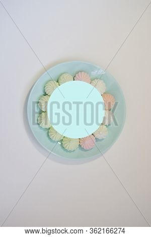 Sweet Paste Colored Bise On A Delicate Blue Plate On A White Table. Good Morning. Flat Lay