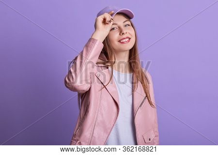 Portrait Of Cheerful Emotional Cute Young Lady Putting Hand On Hat, Smiling Sincerely, Spending Leis