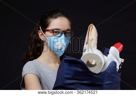 Young Woman In A Valve Of The Respiratory Protective Mask With A Bag Full Of Groceries From The Supe