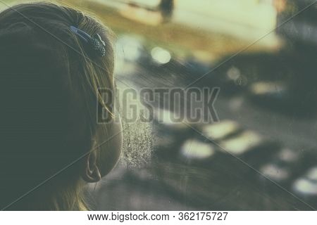 Girl Looks Lonely Through Window By Putting Her Hands On Window Sill