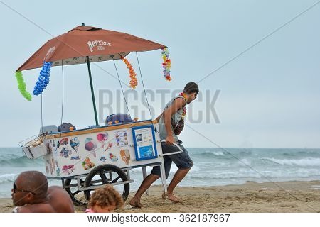 Cap Dagde, France - July 30, 2016:a Man Pulls A Cart With Ice Cream On The Beach