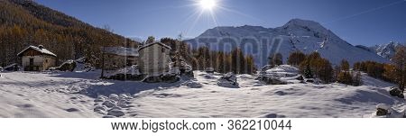 Snowy Village Located In The French Alps With A Blue Sky