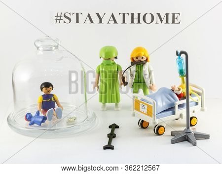 A Toy Figure Of A Child Protected From The Virus And A Child In A Hospital Bed, Two Figures Of Docto