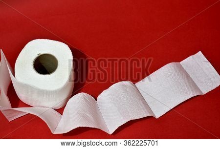 Roll Of Toilet Paper On Red Background