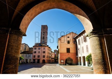 Piazza Risorgimento, Main Square Of Alba (piedmont, Italy) Seen Through The Colonnade Of Saint Lawre