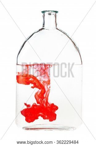 Red Ink Dissolves In Water In Bottle Isolated On White Background
