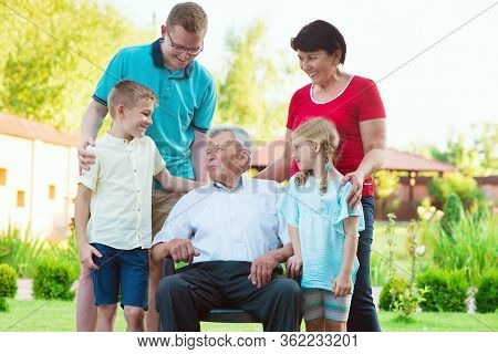 Portrait Of Big Happy Family With Old Grandfather, His Daughter And His Grandchildren At Nurising Ho