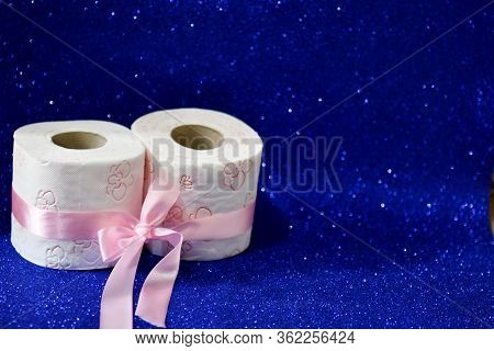 Rolls Of Toilet Paper On Glitter Blue Background