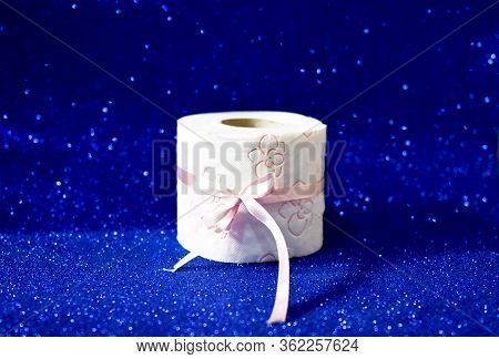 Roll Of Toilet Paper On Glitter Blue Background