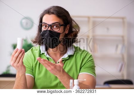 Young man student studying at home in self-isolation concept