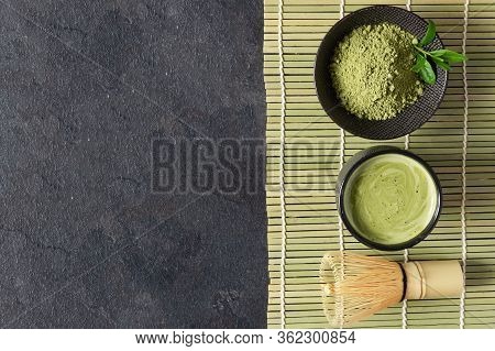Green Matcha Tea Drink And Tea Accessories On Black Background Top View. Japanese Tea Ceremony Conce