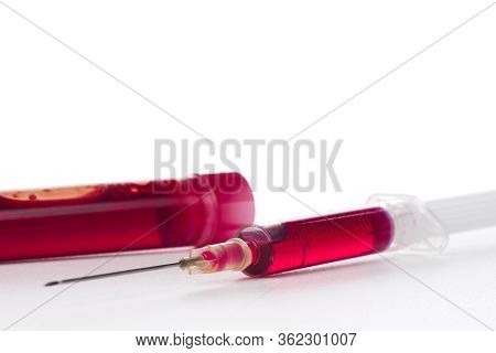 Syringe With Red Medical Injection Vaccine. Isolated On White Background With Copy Space