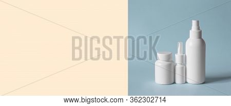 3 White Vials Without Inscriptions For Medicines, Vitamins, Sprays, Liquids On A Blue Background. Mo