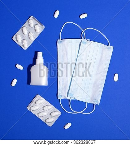 P Revention Of C Oronavirus. Medical Masks, Vitamins, Antiseptic On A Blue Background.