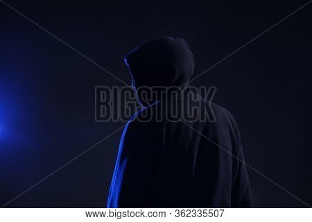 Man In Hood On Dark Background. Cyber Crime