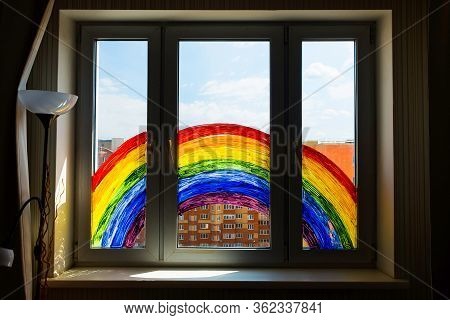 Kid Painting Rainbow During Covid-19 Quarantine At Home. Girl Near Window. Stay At Home Social Media