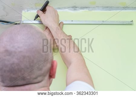 Fastening To The Wall Guide For Stretch Ceiling. Repairers Make Installation Of A Stretch Ceiling