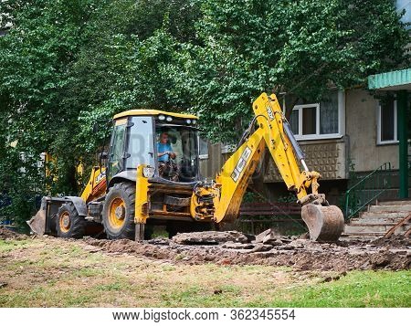 Kharkov, Ukraine - March 2020, Buldozer Remaking And Reconstructing Asphalt Road Near The Civil Buil