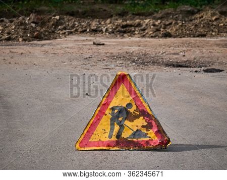 Works Ahead Warning Sign On A Road. Old Damaged Road Sing