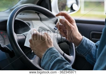Man Hands Cleaning The Steering Wheel With A Wipe And Sanitizer. Covid-19 Or Corona Virus Concept. C