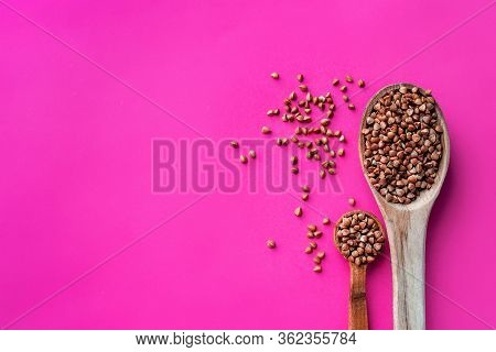 Wooden Spoon Of Roasted Buckwheat On Buckwheat Groat Jar Background, Gluten Free Ancient Grain For H