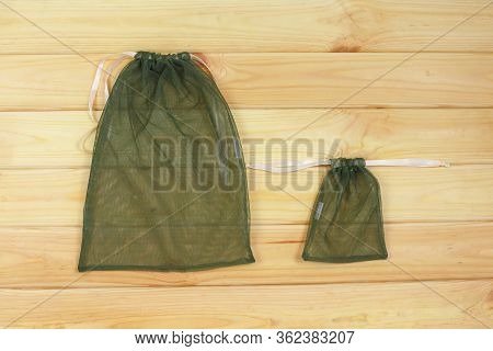 Reusable Eco Friendly Mesh Bags On Wood Background.