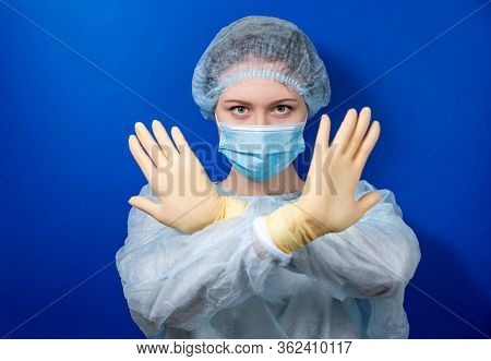 A Young Doctor In A Medical Uniform Makes A Forbidden Gesture With His Hands. Medical Design Concept