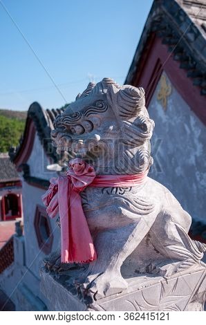 China, Heihe, July 2019: The Statue Of The Lion. Taoist Temple Outside The City In Heihe In The Summ