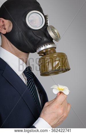 Close Up Portrait Of Man In A Protective Gas Mask With Flower