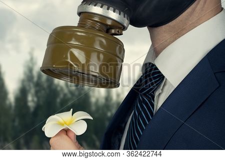 Close Up Portrait Of Man In A Protective Gas Mask With Flower