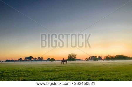 Dramatic And Colorful Sunrise Sky. Dramatic And Colorful Sunrise Or Sunset Sky Over A Grassy Green F