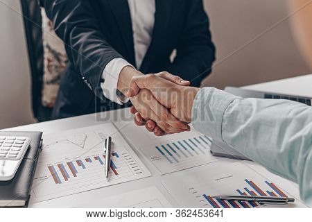Financial accountants and marketers shaking hand to congratulate the double-digit real estate perfor