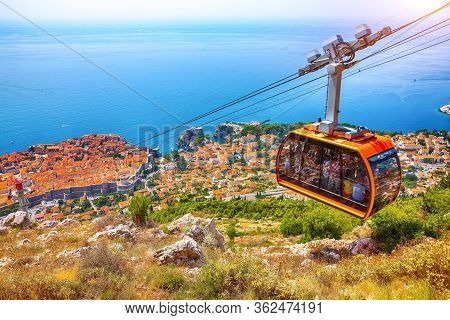 Aerial Panoramic View Of The Old Town Of Dubrovnik With Famous Cable Car On Srd Mountain On A Sunny 