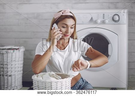 Woman In A Bathroom Near Wash Mashine