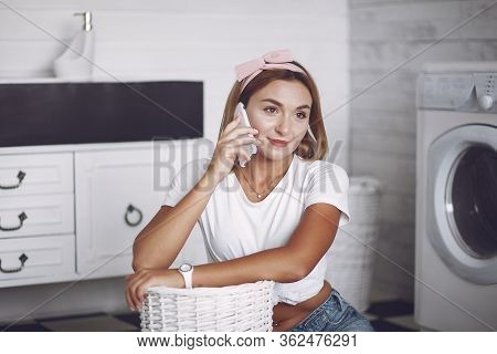 Woman In A Bathroom Near Wash Mashine