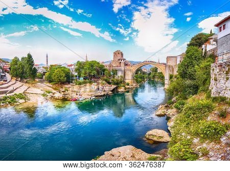 Fantastic Skyline Of Mostar With The Mostar Bridge, Houses And Minarets, During Sunny Day. Location: