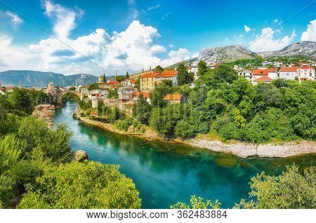 Fantastic Skyline Of Mostar With The Mostar Bridge, Houses And Minarets, During Sunny Day. Location: