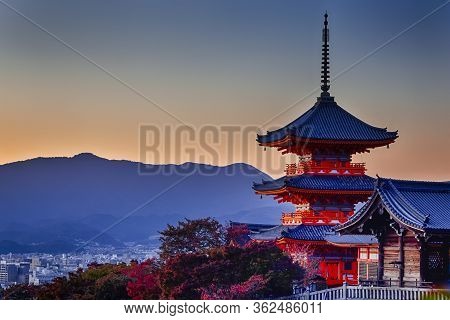 Japanese Heritage. Vivid Sunset Over Kiyomizu-dera Temple Pagoda With Traditional Red Maple Trees In