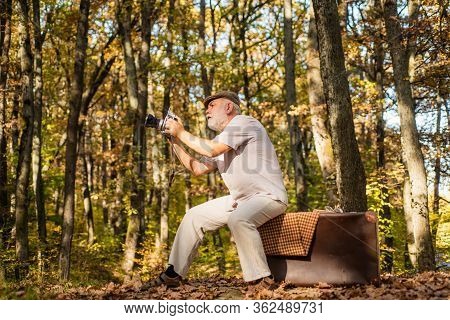 Cameraman Outdoors. Landscape And Nature Photo Shooting. Old Photographer Filming. Professional Phot