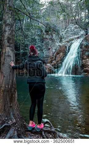 Adult Woman Standing In Front Of Waterfall And Enjoying The View At Kocacay Deresi, Antalya, Turkey.