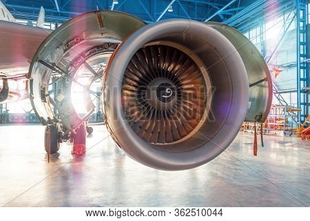 Industrial View Of An Airplane Engine With An Open Hood For Repair In Aviation Hangar, With Bright L