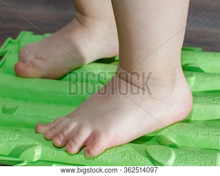 Child On Massage Mat Doing Exercises For Flatfoot Prevention