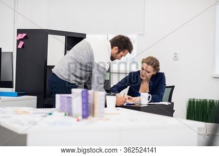 A Businesswoman Explaining Something To Her Employee While Sitti