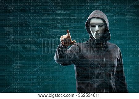 Anonymous Computer Hacker Over Abstract Digital Background. Obscured Dark Face In Mask And Hood. Dat