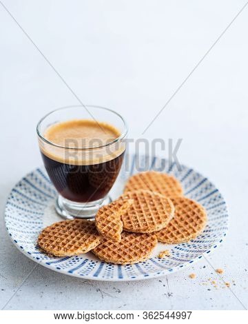 Glass Cup Of Coffee With Dutch Caramel Mini Stroopwafels, Syrupwaffles Cookies On Light Gray Backgro