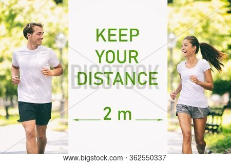 KEEP YOUR DISTANCE Covid-19 two meters warning for social distancing prevention text message sign. People walking in park street talking during walk run jog. Asian woman jogger running with man.