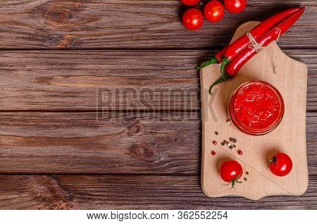 Ajvar Or Pindjur Red Vegetable Spread Or Pepper Paprika And Tomato Mousse In A Glass Jar On A Cuttin