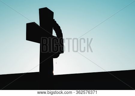Black Outline Of A Christan Cross With A Tiny One Hanging From It. Contrast Of Black Underexposed Cr