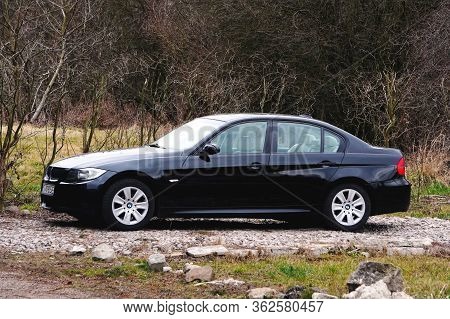 Krakow, Poland 22.03.2020: Black Car Bmw 3 E90 Luxury German Sedan, Parking In City Park. Detail Fro