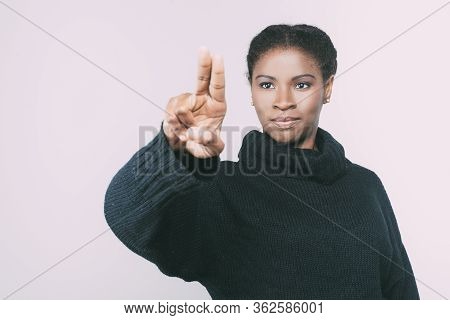 Front View Of Calm Woman Touching Virtual Screen With Fingers. Attractive Young Lady Pressing Someth